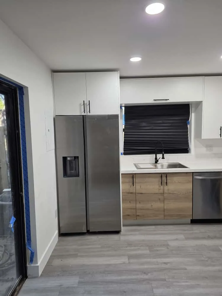Oak and white kitchen with stainless fridge