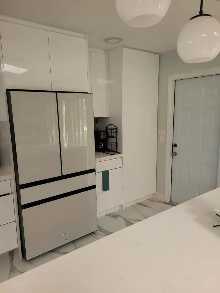 Panel-look built-in fridge in a white gloss kitchen
