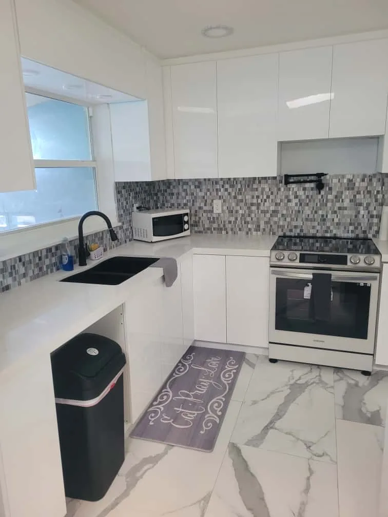 Refreshed white kitchen with mosaic backsplash