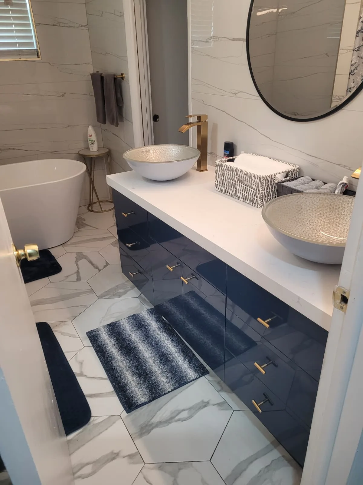 Navy double vanity with vessel sinks and gold hardware